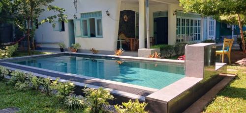 a swimming pool in the yard of a house at Villa Peace Heaven in Galle