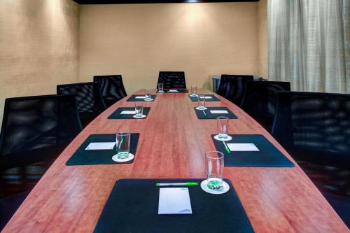 a long table in a conference room with glasses and napkins at Fairfield Inn & Suites by Marriott Anniston Oxford in Oxford
