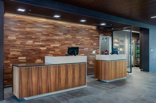 a lobby with a reception desk with a stone wall at Courtyard by Marriott Savannah Airport in Savannah