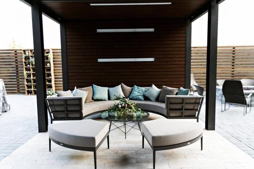 a patio with a couch and chairs and a table at Courtyard by Marriott Savannah Airport in Savannah