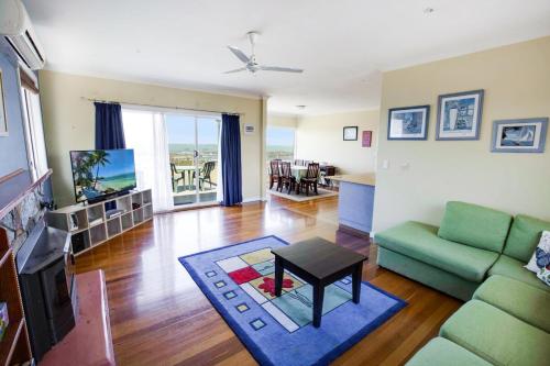 a living room with a couch and a table at Kalimna Holiday House in Kalimna