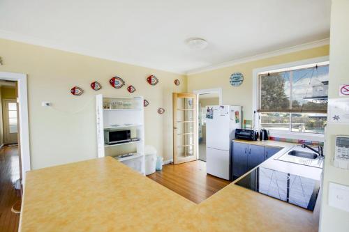 a kitchen with a white refrigerator and a counter top at Kalimna Holiday House in Kalimna