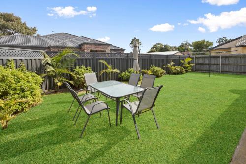 a table and chairs sitting on a lawn at The Aviary in Paynesville