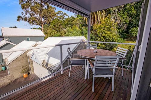 a balcony with a table and chairs on a deck at Bliss by the Bay in Metung