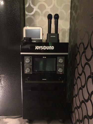 a black microwave with a phone on top of it at X Hotel - Adult Only- in Sayama