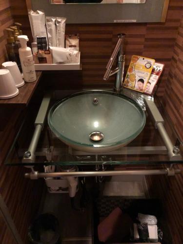a bathroom with a green sink in a room at X Hotel - Adult Only- in Sayama