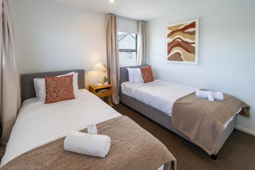 a bedroom with two beds and a window at Beautiful home, Near CBD, Pet Friendly with Carpark in Christchurch