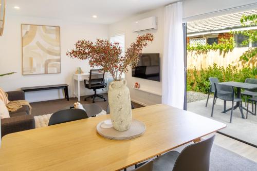 a vase sitting on a table in a living room at Beautiful home, Near CBD, Pet Friendly with Carpark in Christchurch