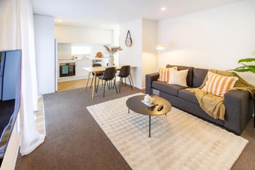 a living room with a couch and a table at Beautiful home, Near CBD, Pet Friendly with Carpark in Christchurch