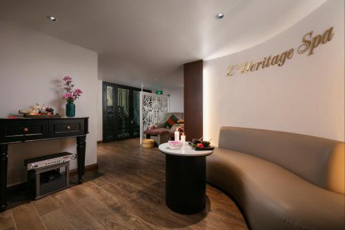 a living room with a couch and a table at Hanoi L'Heritage Hotel & Gym - Spa in Hanoi