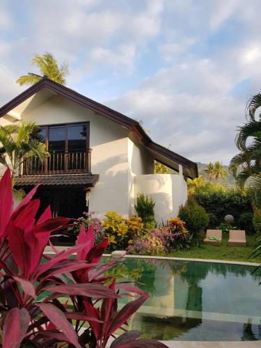 a villa with a pool in front of a house at The Royen - Oaza in Lovina in Lovina