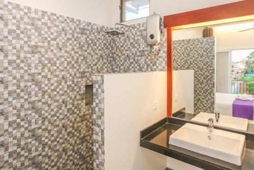 a bathroom with a sink and a mirror at Phan NaTa Residence in Siem Reap