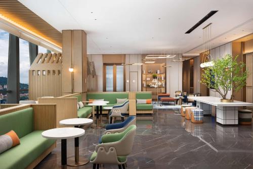 a waiting room with tables and chairs and tablesktop at Hilton Garden Inn Bazhong Bazhou in Bazhong