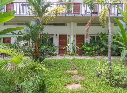 a building with palm trees in front of it at Phan NaTa Residence in Siem Reap