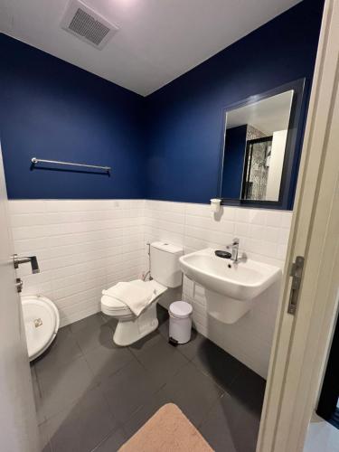 a bathroom with a white toilet and a sink at The Base Central Phuket-C4YW in Phuket