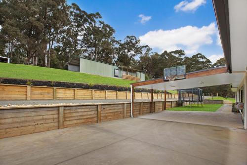 an outdoor basketball court with a basketball hoop at Rivers Edge in Lake Tyers