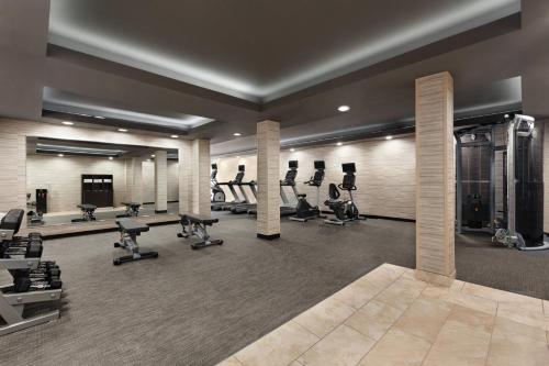 a gym with several treadmills and exercise bikes at Courtyard by Marriott Tulsa Central in Tulsa