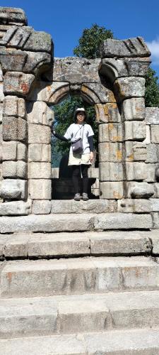 a woman is standing in a stone arch way at Sea Green Guest House in Srinagar