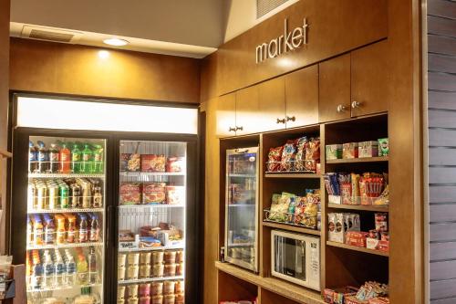 a grocery store with two refrigerators and food at Courtyard by Marriott New Braunfels River Village in New Braunfels