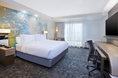 a hotel room with a bed and a desk at Courtyard by Marriott St. Joseph-Benton Harbor in Benton Harbor