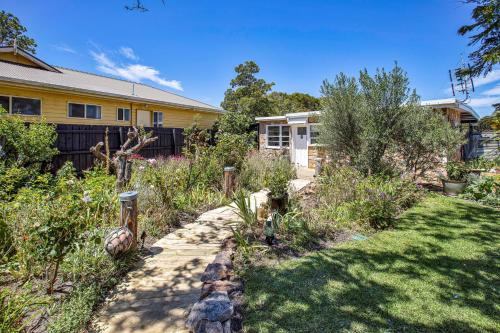 a garden in front of a house at The Fishermans Cottage in Raymond Island