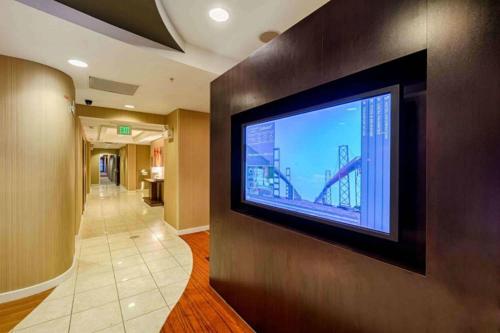 a large flat screen tv on a wall in a hallway at Courtyard by Marriott Salisbury in Salisbury