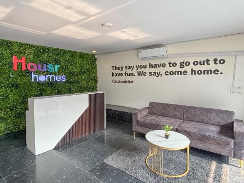 a waiting room with a couch and a table at Housr Sector 28 Near to Phase 1 Metro Station in Gurgaon