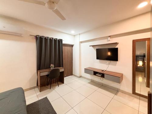 a living room with a tv on the wall at Housr Sector 28 Near to Phase 1 Metro Station in Gurgaon