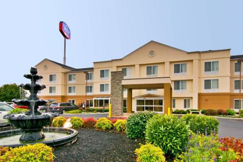 a hotel with a fountain in front of a building at Fairfield Inn & Suites Clarksville in Clarksville
