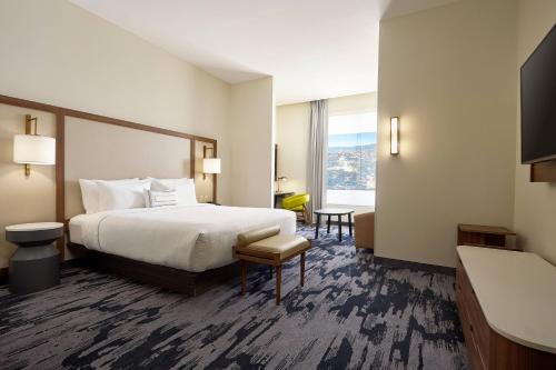 a hotel room with a bed and a large window at Fairfield Inn & Suites Silao Guanajuato Airport in Silao