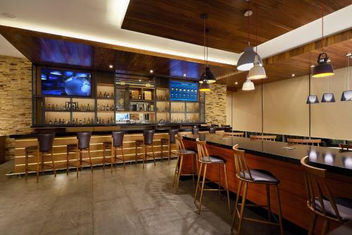 a bar with a bunch of chairs and a counter at Fairfield Inn & Suites Silao Guanajuato Airport in Silao