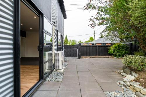 a glass door of a house with a patio at Refresh At Fraser in Twizel