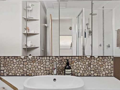 un baño con lavabo y ducha en Beachside Family Haven, en Inverloch