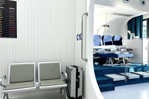 a waiting room with chairs and a table and a table and chairs at Dooga Ins-Boeing 777X Seaview in Johor Bahru