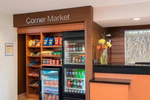 a counter in a store with a corner market refrigerator at Fairfield Inn & Suites by Marriott Bloomington in Bloomington