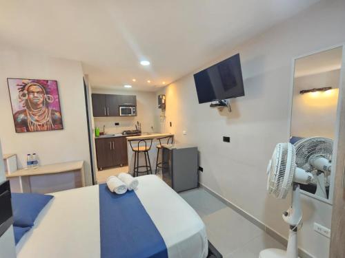 a hospital room with a bed and a kitchen at Andaliving Campo Valdés in Medellín