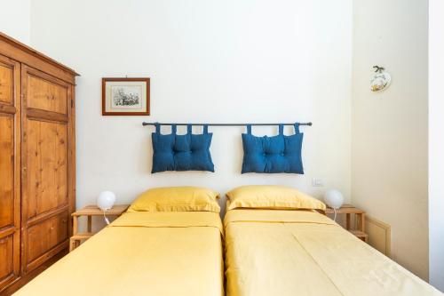 En eller flere senge i et værelse på Casa Elena - ItalyHolidayHouse