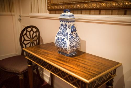 a blue and white vase sitting on a wooden table at Redearth Boutique Hotel in Mount Isa