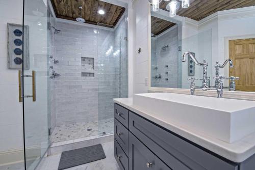 a white bathroom with a sink and a shower at Cowboy at Sunset Key in Pensacola