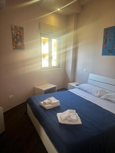 a bedroom with a bed with two towels on it at B&B Scilla Town in Scilla