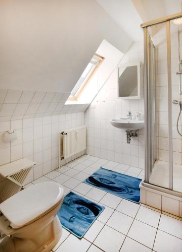 a bathroom with a toilet and a sink at Waldstr 7 Wo 6 in Prerow