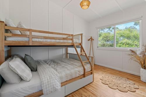 a bedroom with two bunk beds and a window at Wine Down McLaren Vale, a cosy vineyard retreat in McLaren Vale