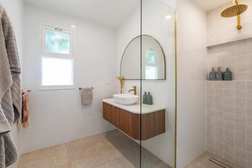 a bathroom with a sink and a mirror at Wine Down McLaren Vale, a cosy vineyard retreat in McLaren Vale