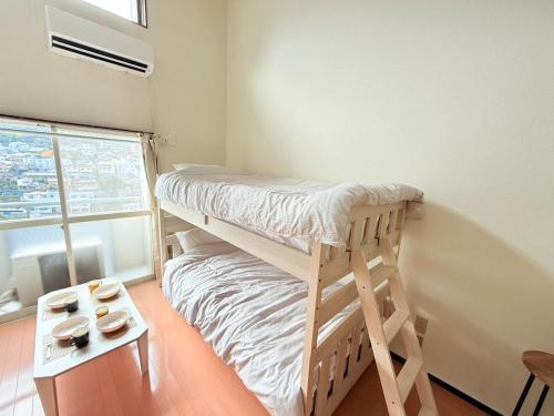 Postel nebo postele na pokoji v ubytování 高平ハウス Room203