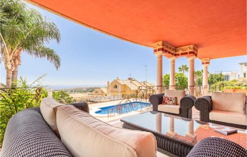 a patio with furniture and a view of a swimming pool at 6 Bedroom Awesome Home In Marbella in Marbella