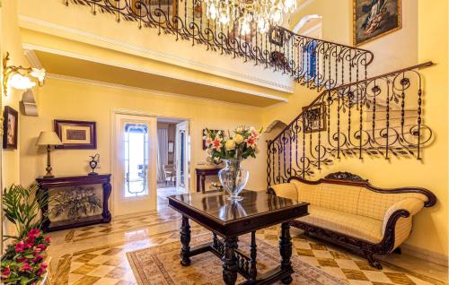 a living room with a couch and a table at 6 Bedroom Awesome Home In Marbella in Marbella