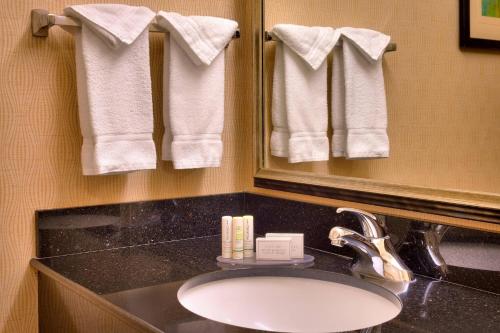 a bathroom with a sink and a mirror and towels at Fairfield Inn & Suites Boise Nampa in Nampa
