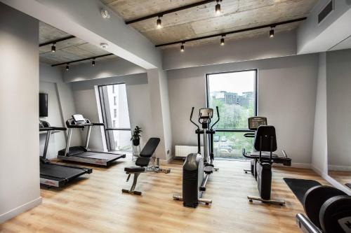 a gym with treadmills and exercise equipment in a room at Courtyard by Marriott Vilnius City Center in Vilnius