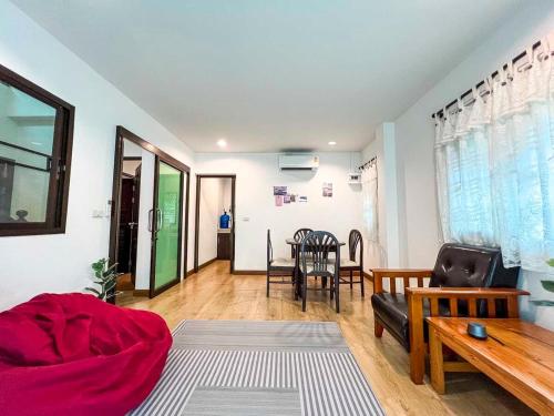 a living room with a couch and a table at Cute House in Local Area, near CMU in Chiang Mai