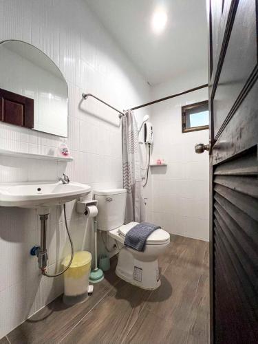 a bathroom with a toilet and a sink at Cute House in Local Area, near CMU in Chiang Mai